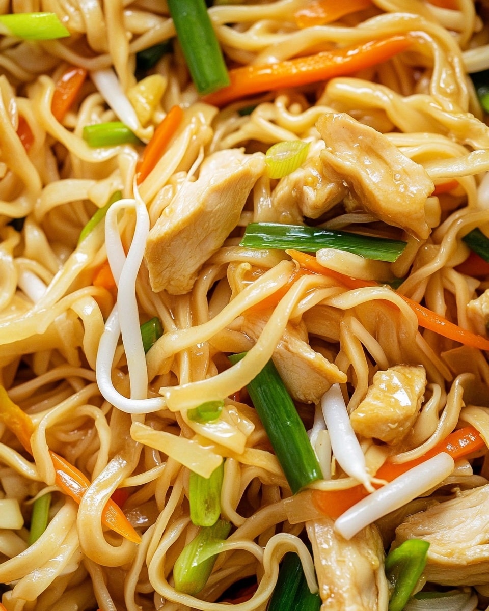 The image shows a close-up view of a noodle dish with three main layers mixed together: soft, light yellow noodles tangled in the middle and edges; thin strips of light brown cooked chicken scattered evenly; and thinly sliced vegetables including bright orange carrot sticks, pale white bean sprouts, and fresh green onion pieces spread throughout. The textures look tender and slightly glossy, indicating a light sauce coating. The background features a white marbled texture. photo taken with an iphone --ar 4:5 --v 6.1