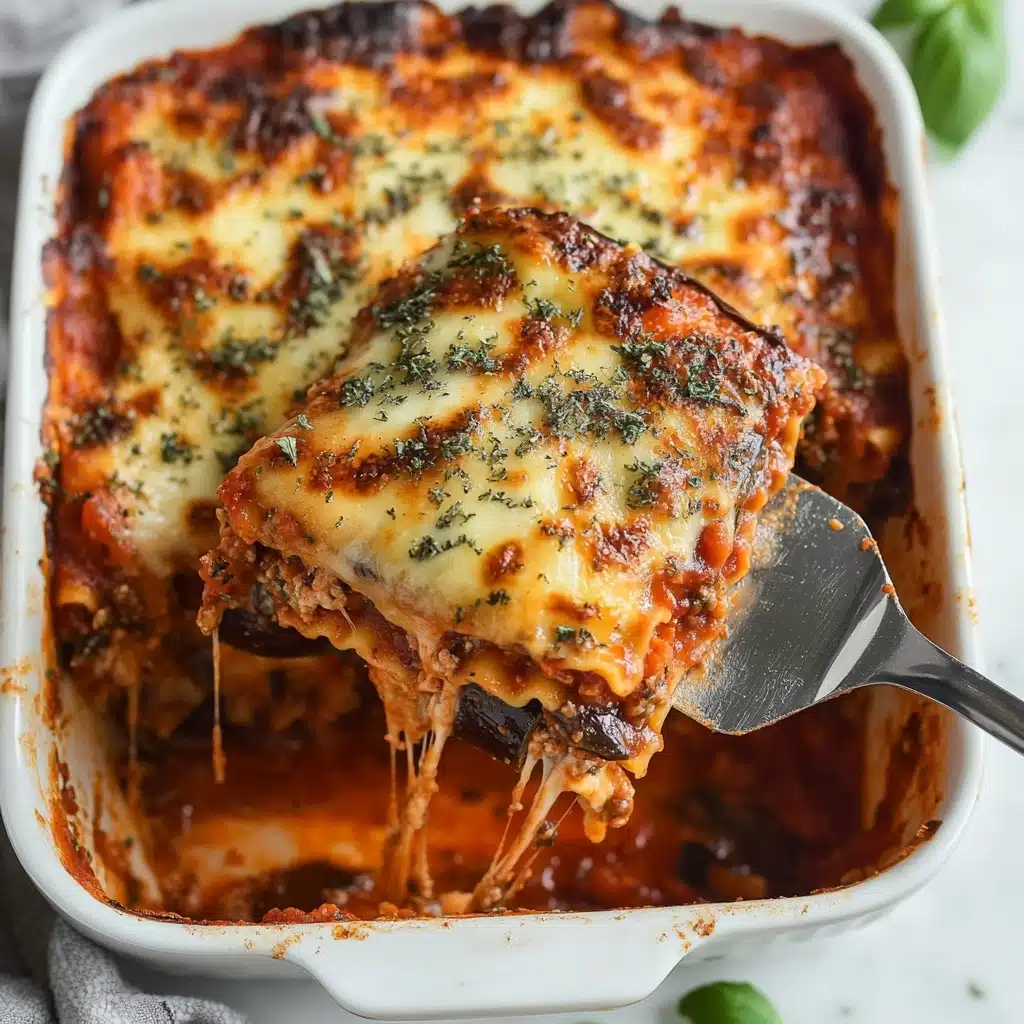 Provençal Eggplant Tomato Gratin, Eggplant and Tomato Casserole, French Vegetable Gratin, Vegetarian Eggplant Bake, Mediterranean Eggplant Dish A white baking dish filled with a baked lasagna, showing three visible layers: the top layer is golden-brown melted cheese covered with dried green herbs, the middle layer has a red tomato sauce with bits of herbs and some eggplant pieces, and the bottom layer appears to be pasta with sauce. A stainless steel spatula holds a square piece lifted from the dish, with cheese strings slightly stretching from the lasagna in the dish. The dish sits on a white marbled surface with a small green basil leaf nearby.