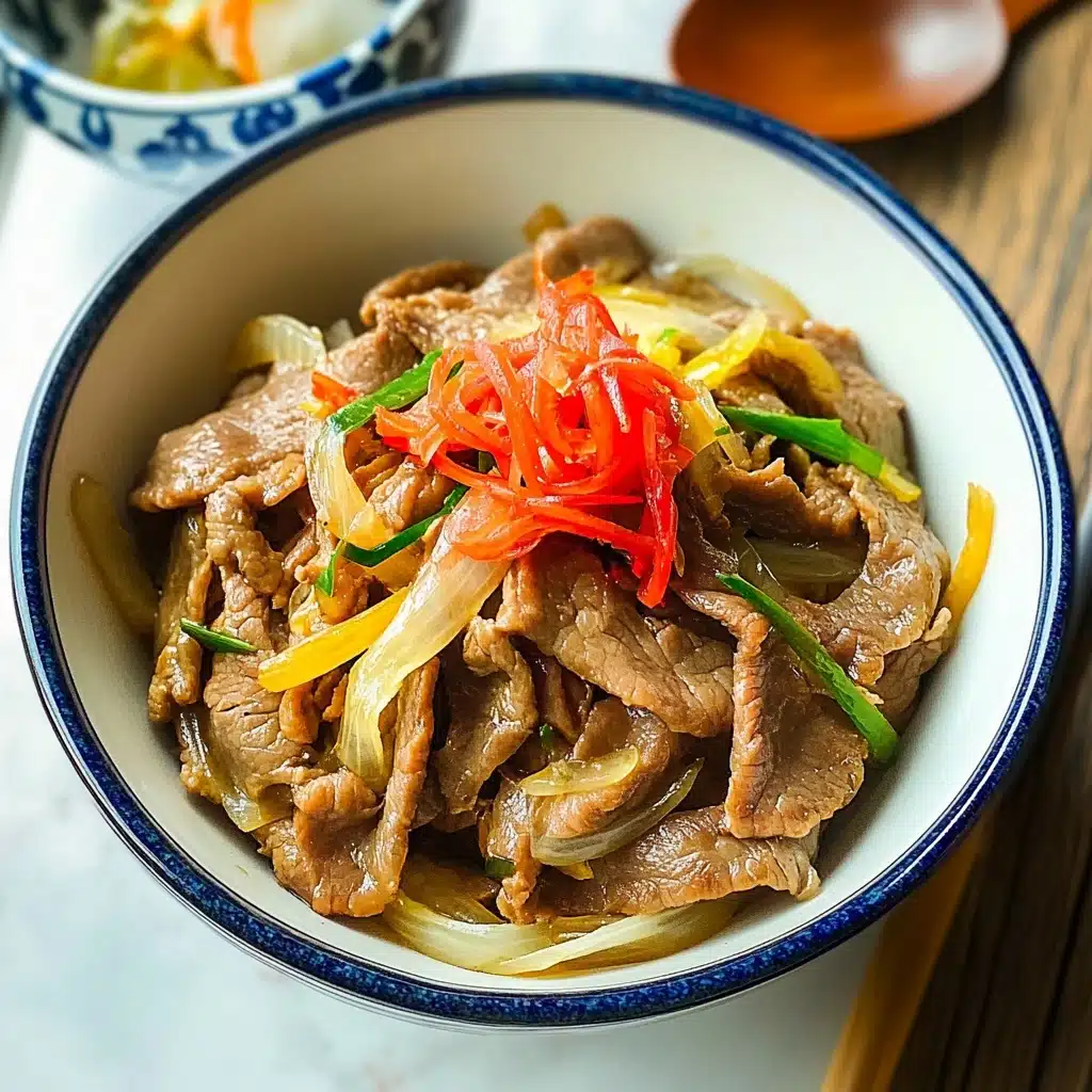 Gyudon Japanese Beef Rice Bowl, Japanese Beef Rice Bowl, Gyudon recipe, easy Japanese beef dish, homemade Gyudon The dish is served in a white bowl with a thin blue rim, filled with thinly sliced cooked meat that is light brown with a tender texture, mixed with translucent yellow onion slices and bright green scallions. On top, there is a small heap of finely sliced bright red pickled ginger adding a pop of color. The bowl is placed on a white marbled surface, next to a wooden spoon and a pair of chopsticks with red and white details. Part of a white bowl with blue patterns is visible on the side, slightly open.
