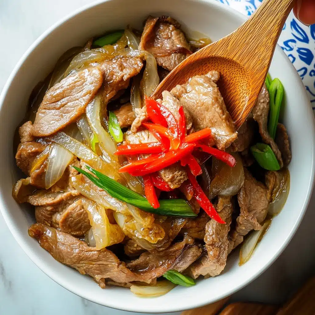 Gyudon Japanese Beef Rice Bowl, Japanese Beef Rice Bowl, Gyudon recipe, easy Japanese beef dish, homemade Gyudon A white bowl filled with thin slices of cooked brown meat layered with translucent cooked onions and bits of green onion. On top, there are small strips of bright red pickled vegetable adding a pop of color. A wooden spoon is scooping some of the meat and onions, held by a woman's hand, while another woman's hand holds the bowl on the left. The bowl is placed on a white marbled surface with a partially visible white lid with blue and beige patterns on the right side.