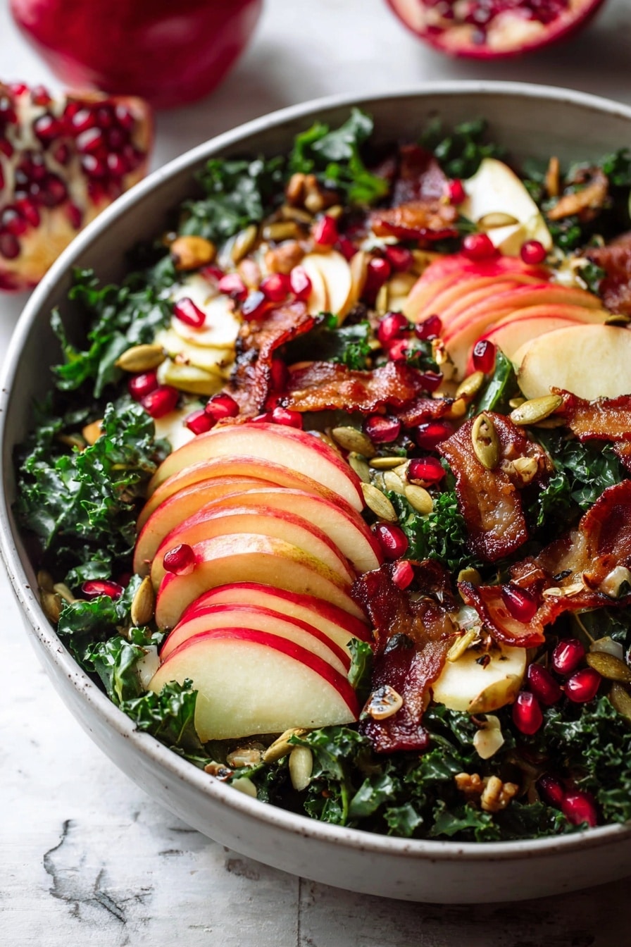 A white bowl filled with a fresh salad is placed on a white marbled texture. The bottom layer has dark green curly kale. On top, there are thinly sliced red apples arranged in small stacks showing red and light yellow skin with white inside. Bright red pomegranate seeds are scattered all over the salad, adding small round pops of color. There are pieces of crispy golden-brown bacon spread unevenly across the bowl. Small roasted pumpkin seeds are sprinkled lightly over the salad, giving a crunchy texture. The colors are deep green, red, and brown with a mix of soft and crispy textures. Photo taken with an iphone --ar 2:3 --v 7 - Fall Harvest Honeycrisp Apple and Kale Salad, autumn apple kale salad, healthy fall salads, Honeycrisp apple salad, kale salad with prosciutto