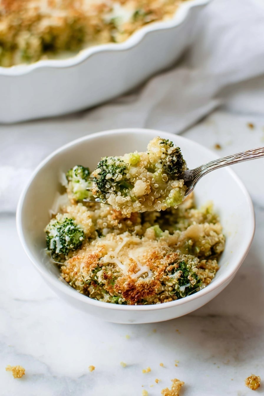 A close-up view shows a white bowl with a textured rim filled with a broccoli quinoa casserole. The dish has several layers visible: bright green broccoli pieces mixed with light tan quinoa, topped with a crumbly golden-brown crust sprinkled with some melted white cheese strands. The casserole looks baked, with some crispy bits giving it a crunchy texture. A silver fork stands inside the bowl on the right side, partially covered in the casserole. The bowl sits on a soft white cloth over a white marbled surface. Photo taken with an iphone --ar 2:3 --v 7 - Better Broccoli Casserole, healthy broccoli casserole, cheesy broccoli bake, quinoa broccoli casserole, easy vegetable casserole