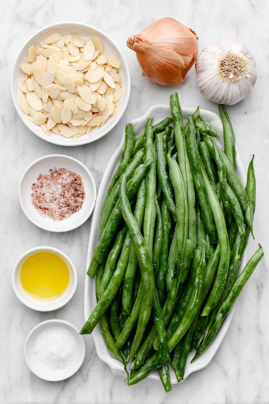 Flat lay of fresh haricot vert green beans trimmed and blanched, a small pile of golden toasted sliced almonds, a small white bowl of extra-virgin olive oil, a whole uncracked shallot, a small white bowl of sea salt, a whole garlic clove, a small white bowl of fresh lemon juice, and a few cracks of freshly ground black pepper arranged perfectly symmetrically on simple white ceramic dishes and bowls, placed on a clean white marble surface, soft natural light, photo taken with an iPhone, professional food photography style, fresh ingredients, white ceramic bowls, no bottles, no duplicates, no utensils, no packaging --ar 2:3 --v 7 --p awthu7i m7354615311229779997 - Easy Green Beans Almondine, green beans almondine, green bean side dish, healthy green bean recipe, quick green bean recipes