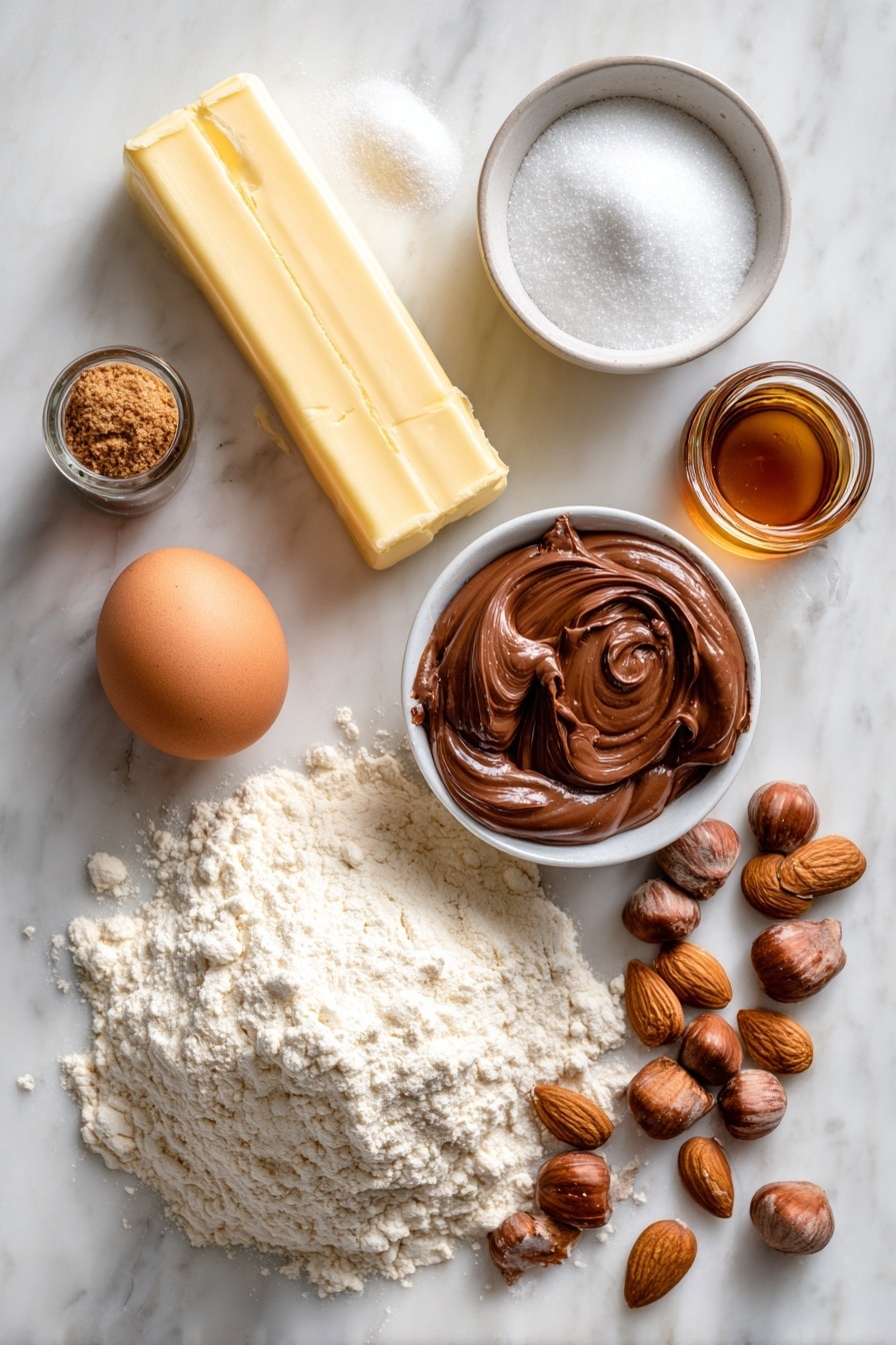 Flat lay of a stick of unsalted butter, a small pile of white sugar, a few spoonfuls of brown sugar, a single large egg, a small glass bottle of vanilla extract, a bowl of flour with visible texture, a dollop of smooth Nutella hazelnut spread, and a scattering of almond nuts, all beautifully arranged on a white marble surface, photo taken with an iphone --ar 2:3 --v 7 - Nutella Thumbprint Cookies, soft buttery cookies with Nutella, easy Nutella cookie recipe, chocolate hazelnut cookies, thumbprint cookie ideas