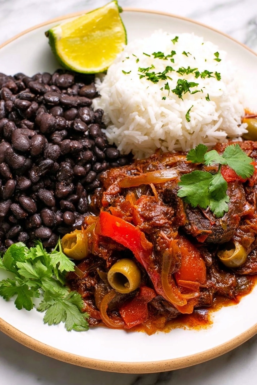 A white plate holds three main layers of food on a white marbled surface. On the left side is a thick layer of black beans with a slightly soft texture made from many whole beans. Next to the beans, on the right side of the plate, is a mound of fluffy white rice with a light, grainy texture. In the front and center, there is a layer of rich, dark red stew with visible pieces of green olives and slices of red bell pepper, covered in a thick, sauce with a chunky texture. A bright yellow lemon wedge rests on the left side of the plate, and a small sprig of fresh green cilantro is placed on top of the stew, adding a touch of vibrant color. Photo taken with an iphone --ar 2:3 --v 7 - Slow Cooker Ropa Vieja, Cuban shredded beef stew, easy Cuban beef recipe, crockpot Ropa Vieja, authentic Cuban stew