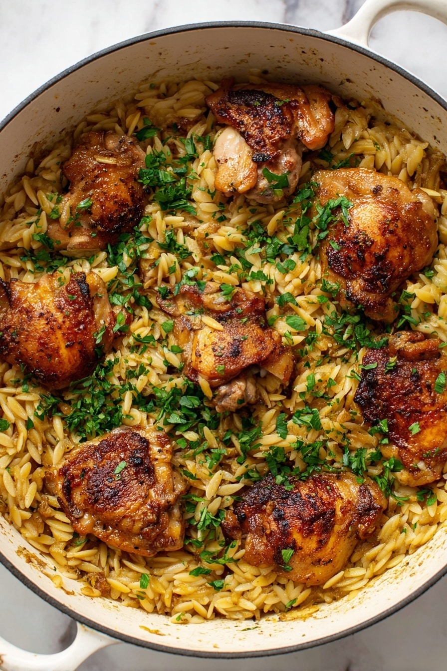 A white pot filled with light golden orzo pasta as the base layer, topped with five crispy browned chicken thighs spread evenly across the pasta. The chicken has a slightly shiny texture from cooking, with a mix of golden and darker brown spots. Bright green chopped herbs are sprinkled generously on top, adding a fresh contrast to the warm tones of the chicken and pasta. The pot sits on a white marbled surface. Photo taken with an iphone --ar 2:3 --v 7 - One Pot Garlic Butter Chicken and Orzo, Easy One Pot Chicken and Orzo, Creamy Garlic Chicken with Orzo, Quick One Pot Chicken Dinner, Juicy Chicken Thighs with Orzo