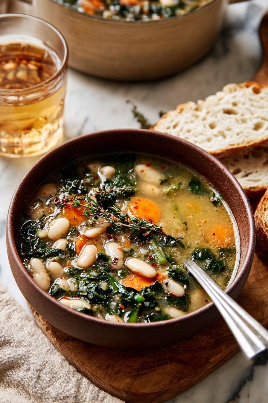 A bowl of soup with light golden broth fills the bowl, showing two layers of ingredients: the first layer has white beans and bright orange carrot slices, while the second layer includes dark green leafy herbs and some small herbs sprinkled on top. The bowl is brown and sits on a wooden board with pieces of white bread beside it. A shiny silver spoon rests inside the bowl. Behind the bowl, a clear glass of light brown drink and a large beige pot can be seen, all placed on a white marbled surface with a beige cloth underneath. Photo taken with an iphone --ar 2:3 --v 7 - Hearty Tuscan White Bean Soup, Tuscan White Bean Soup, Italian Bean Soup, Healthy White Bean Soup, Comforting Tuscan Soup