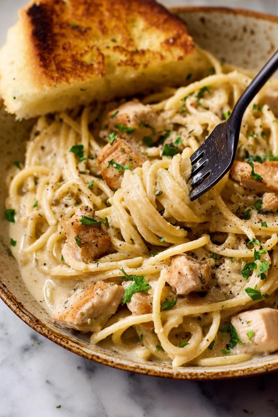 The image shows two bowls of creamy chicken pasta placed on a white marbled surface. Each bowl is filled with creamy white sauce-coated pasta strands intertwined with small pieces of light golden cooked chicken. The pasta is topped with a sprinkle of grated parmesan cheese and fresh green parsley leaves scattered over the dish. One bowl in the foreground features two golden brown toasted bread pieces resting against the edge. The bowls are beige with a speckled pattern and a spoon is visible inside the bowl closer to the camera. The overall look is warm and inviting, with soft textures and subtle color contrasts. Photo taken with an iphone --ar 2:3 --v 7 - Garlic Parmesan Chicken Pasta, chicken pasta recipes, creamy garlic pasta, easy weeknight dinner, homemade pasta with chicken