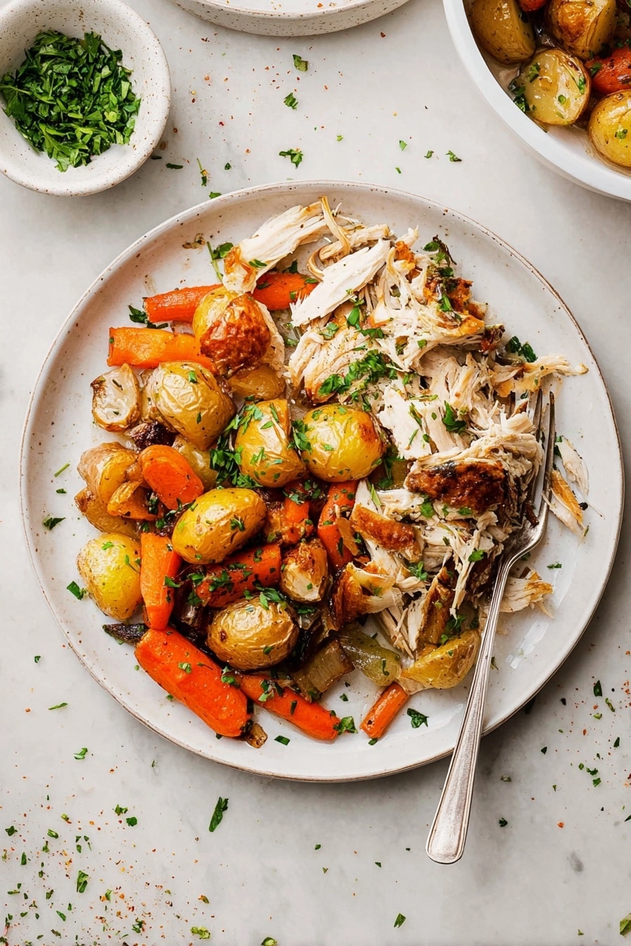 The dish shows a white round plate filled with two main layers: on the left side, there is shredded white meat with golden-brown skin pieces scattered on top, adding texture and color contrast; on the right side, there is a mix of roasted vegetables including small golden-brown potatoes, bright orange carrot pieces, and browned onions, all lightly charred and scattered with chopped green herbs for freshness. A silver fork rests partly on the plate’s edge, pointing inward. Above and behind the plate, a small white bowl with chopped green herbs is visible, placed on a white marbled surface scattered with a few herbs and seasoning bits. Photo taken with an iphone --ar 2:3 --v 7 - Slow Roasted Whole Chicken with Herbs and Vegetables, roasted chicken recipe, herb roasted chicken, easy Sunday dinner, healthy roasted chicken