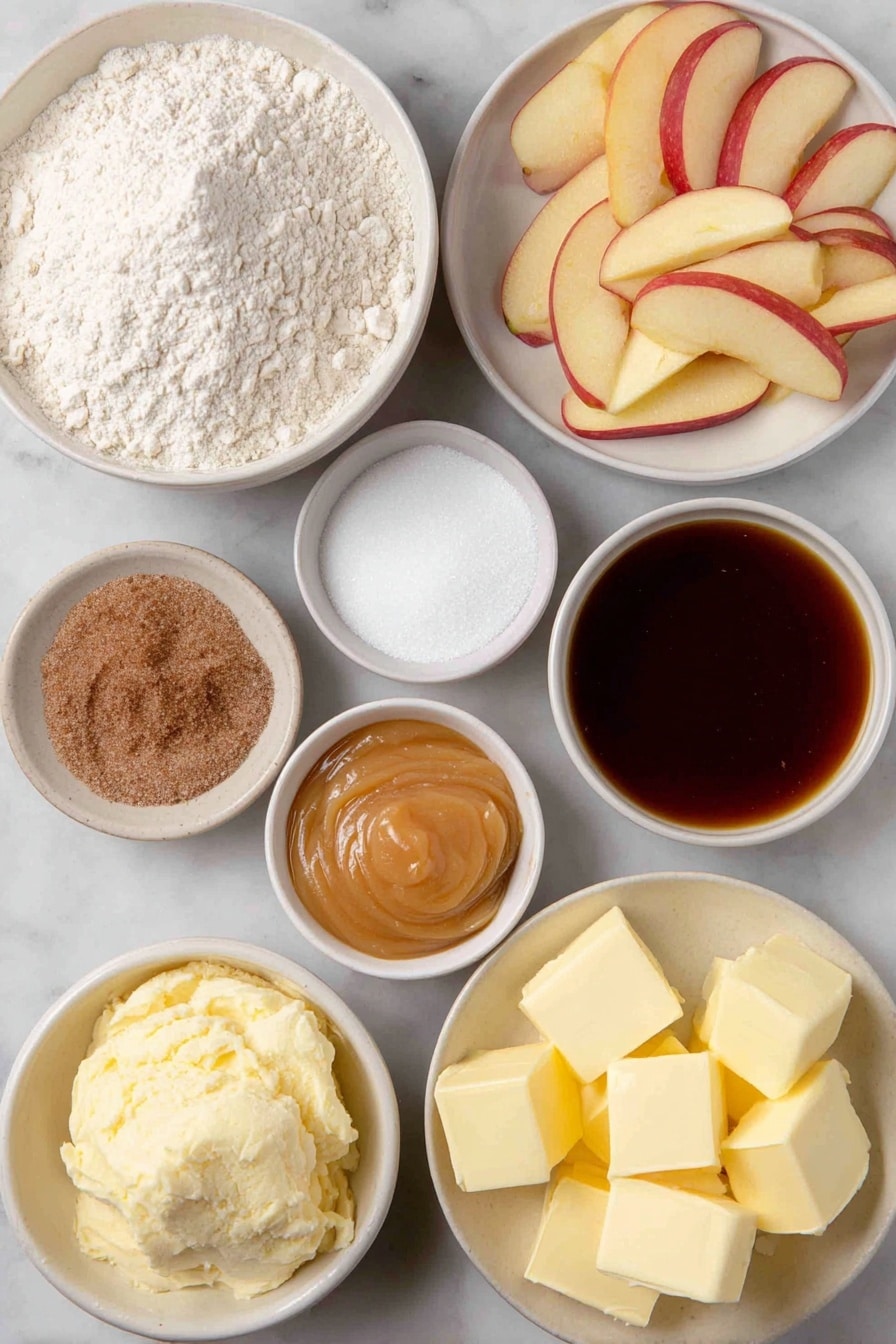 Flat lay of a small mound of all-purpose flour, a few tablespoons of granulated sugar in a small white bowl, a small heap of active dry yeast granules, a pinch of salt in a tiny white bowl, a small white bowl with water, a small white bowl with milk, cubes of fresh butter, several peeled and thinly sliced tart apples arranged neatly, a small white bowl with brown sugar, a small white bowl with caramel ice cream topping, a small white bowl of ground cinnamon, a small white bowl containing a mixture of flour and sugar, and cold butter cubes grouped together, placed on a clean white marble surface, soft natural light, photo taken with an iPhone, professional food photography style, fresh ingredients, white ceramic bowls, no bottles, no duplicates, no utensils, no packaging --ar 2:3 --v 7 --p awthu7i m7354615311229779997 - Apple Pizza with Cream Cheese, Caramel, and Streusel, apple dessert recipe, easy fruit pizza, cinnamon apple tart, caramel apple dessert