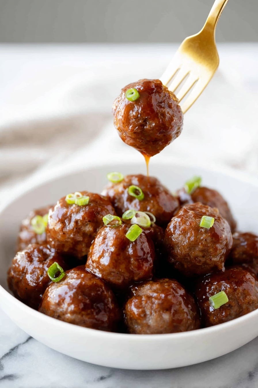 A white bowl filled with about a dozen shiny, brown meatballs covered in a thick, glossy sauce. The meatballs have a smooth, sticky texture and are garnished with small pieces of green onion scattered on top. One meatball is held above the bowl by a gold fork, with sauce dripping down from it. The scene is set on a white marbled surface. Photo taken with an iphone --ar 2:3 --v 7 - Sticky Honey Garlic Meatballs, Honey Garlic Meatballs, Easy Dinner Recipes, Quick Weeknight Dinners, Family Favorite Meatball Recipes