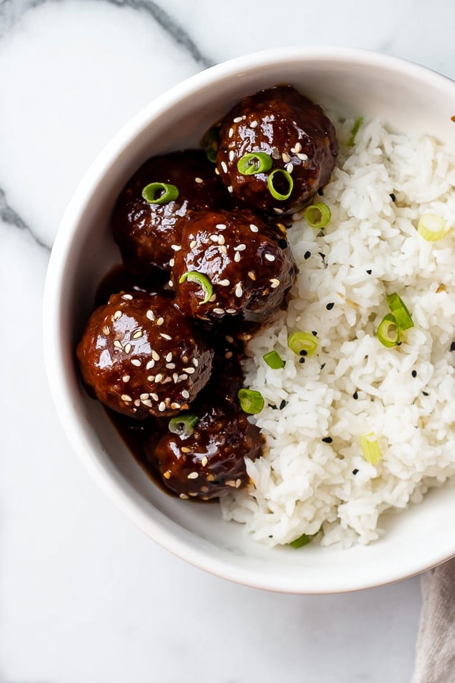A white bowl sits on a white marbled surface, filled halfway with soft, fluffy white rice that has a few small green onion slices scattered on top. On one side of the bowl, four shiny, dark brown meatballs covered in a thick, glossy sauce are neatly placed. The meatballs are also sprinkled with sesame seeds and small pieces of green onion, adding contrast to their smooth, rich texture. photo taken with an iphone --ar 2:3 --v 7 - Sticky Honey Garlic Meatballs, Honey Garlic Meatballs, Easy Dinner Recipes, Quick Weeknight Dinners, Family Favorite Meatball Recipes