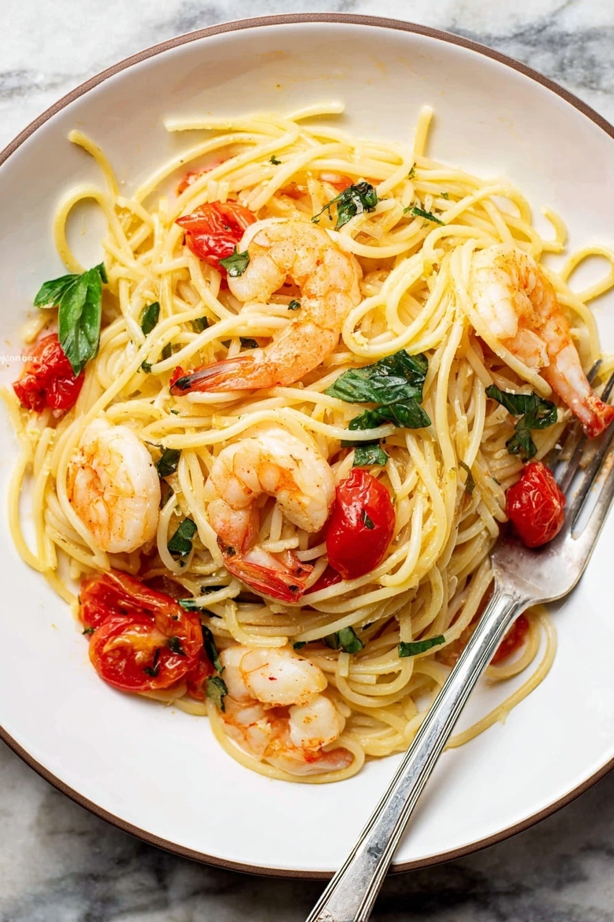 The image shows a black pan filled with cooked spaghetti pasta mixed with orange-pink shrimp and small bits of red tomato scattered throughout. Bright green basil leaves lay on top in three spots, adding fresh color. The spaghetti noodles are creamy yellow and twisted around a silver fork resting inside the pan on the right side. The pan sits on a white marbled surface with a wooden texture background faintly visible. The scene looks warm and inviting, with a mix of textures from smooth pasta to plump shrimp and torn basil leaves. Photo taken with an iphone --ar 2:3 --v 7 - Shrimp Tomato Basil Pasta, easy seafood pasta recipe, quick shrimp pasta, healthy shrimp pasta dish, flavorful pasta with cherry tomatoes