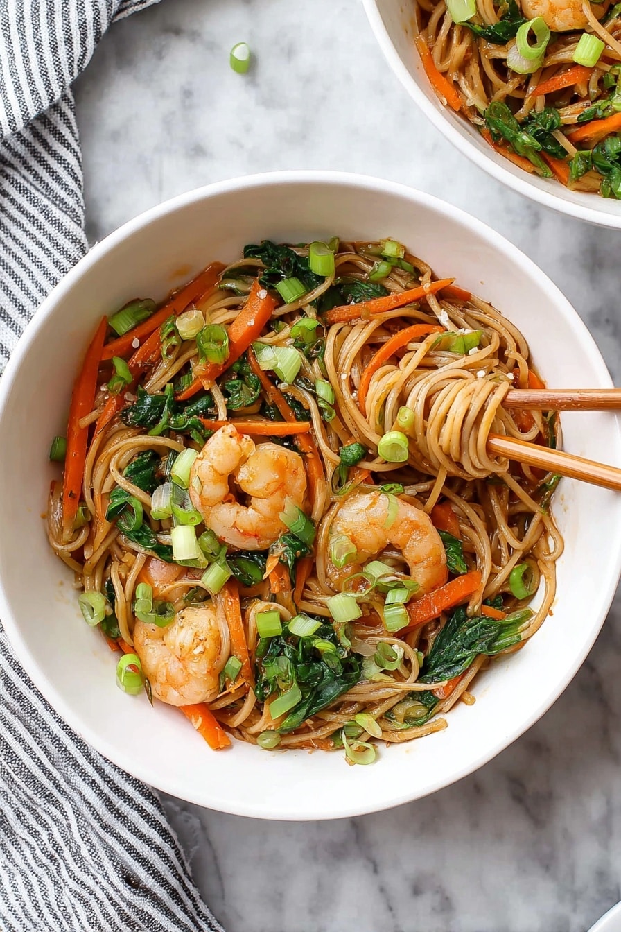 A large black pan filled with a stir-fry of light brown noodles mixed with green bok choy leaves, thin orange carrot strips, and small white chunks of bok choy stems, scattered with cooked shrimp that are pink with a slight shine. Bright green chopped scallions are sprinkled on top, adding freshness. A pair of metal tongs lifts a mix of noodles and shrimp from the pan. The pan rests on a white marbled surface with a clear glass bowl holding more chopped green scallions in the background. A beige cloth is draped on the upper left side. photo taken with an iphone --ar 2:3 --v 7 - Shrimp Lo Mein Stir Fry, Shrimp Lo Mein, stir fry recipes, easy Asian dinner, quick shrimp noodle dish