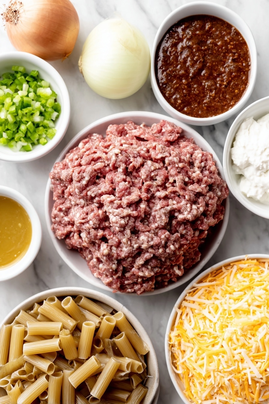 Flat lay of a small mound of fresh lean ground beef, a halved yellow onion with one half chopped, a few dried reddish-brown taco seasoning flakes scattered, a small white ceramic bowl filled with bright green chopped chilies, another small white bowl holding smooth, rich red enchilada sauce, a third small white bowl containing golden chicken broth, a neat pile of uncooked ziti pasta tubes, a small white bowl of thick creamy white sour cream, and a compact pile of shredded pale orange cheddar cheese, all arranged symmetrically on a clean white marble surface, soft natural light, photo taken with an iPhone, professional food photography style, fresh ingredients, white ceramic bowls, no bottles, no duplicates, no utensils, no packaging --ar 2:3 --v 7 --p m7354615311229779997 - Cheesy Enchilada Pasta Skillet, enchilada pasta, cheesy skillet dinner, quick enchilada pasta, one-pot cheesy pasta