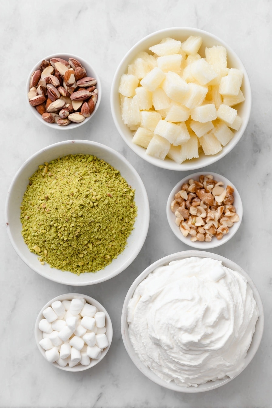 Flat lay of a small mound of bright green pistachio pudding powder, a simple white ceramic bowl filled with crushed pineapple chunks with juice, a small white bowl overflowing with white miniature marshmallows, scattered light brown chopped nuts, and a neat dollop of fluffy white whipped topping arranged on a simple white ceramic plate, all placed on a clean white marble surface, soft natural light, photo taken with an iPhone, professional food photography style, fresh ingredients, white ceramic bowls, no bottles, no duplicates, no utensils, no packaging --ar 2:3 --v 7 --p m7354615311229779997 - Easy Watergate Salad, Watergate Salad ingredients, quick fruit salad, classic dessert recipes, no-bake party desserts