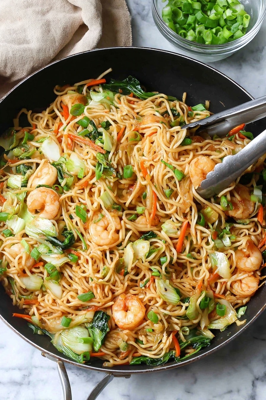 A large black pan is filled with a colorful stir-fry of noodles, shrimp, and vegetables. The base layer has light brown noodles that are thin and mixed with bright green pieces of bok choy and carrot sticks in orange. On top are pink shrimp, slightly browned with black pepper sprinkled on them, scattered throughout. Small pieces of green onions are spread over the whole dish, adding fresh green color. Chopsticks hold a small bundle of noodles and shrimp above the pan. In the background, a small clear glass bowl holds more green onions, and a light wooden pepper grinder is visible. The scene sits on a white marbled textured surface with a light gray cloth napkin beside the pan photo taken with an iphone --ar 2:3 --v 7 - Shrimp Lo Mein Stir Fry, Shrimp Lo Mein, stir fry recipes, easy Asian dinner, quick shrimp noodle dish