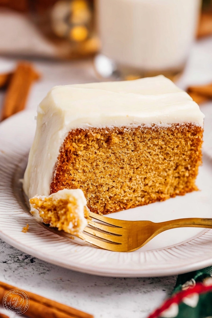 The image shows a slice of thick, light brown cake with a moist texture, topped with a thick white frosting layer covering the top and sides. The slice is placed on a white plate with a subtle embossed design along the edge. A golden fork is cutting into the cake slice. The background has a white marbled texture with blurred elements including cinnamon sticks and a glass cup. Warm lighting highlights the soft texture of the frosting and the crumb of the cake. Photo taken with an iphone --ar 2:3 --v 7 - Eggnog Bread with Rum Extract, holiday eggnog bread recipes, festive holiday bread, spiced eggnog bread, rum extract holiday baking