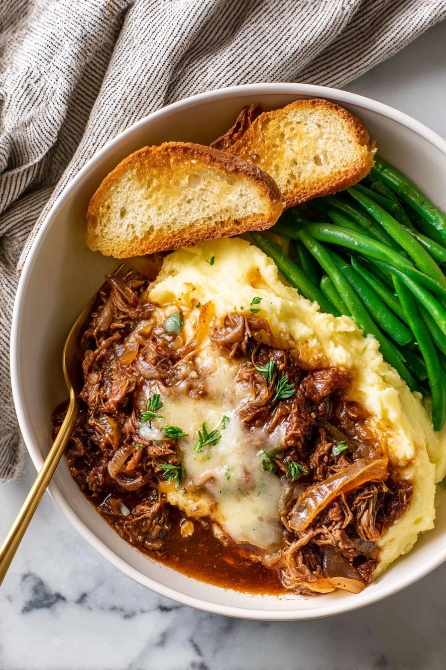 In a white bowl placed on a white marbled surface, there is a dish made of several layers: the bottom left layer is smooth, pale yellow mashed potatoes, topped with a thick layer of rich brown meat with melted white cheese and cooked onions covering the center. To the right, there are bright green cooked green beans stacked neatly. At the top left, two slices of toasted bread rest on the mashed potatoes, all under warm natural light. A golden fork is partly inserted into the mashed potatoes near the meat. A soft, striped towel is seen in the top left corner. Photo taken with an iphone --ar 2:3 --v 7 - French Onion Pot Roast, French Onion Pot Roast recipe, hearty beef pot roast with caramelized onions, tender chuck roast in French onion flavors, easy French onion beef dinner