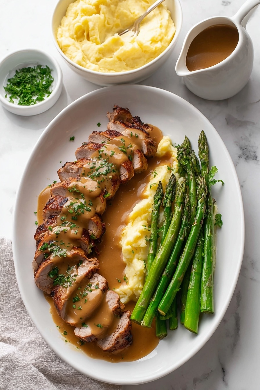 The image shows a white oval plate on a white marbled surface with sliced grilled meat arranged in two rows on the left side. The meat is covered with a smooth brown sauce and sprinkled with chopped green herbs. Next to the meat on the right side are several steamed asparagus spears that are bright green and glossy. Behind the meat and asparagus, there is a white bowl filled with creamy pale yellow mashed potatoes with a slightly uneven smooth surface. In the top left corner on the white marbled surface is a small white bowl with fresh chopped herbs. On the bottom right corner, a white pitcher contains more brown sauce, partially visible. The photo has soft lighting and a clean, fresh presentation style. Photo taken with an iphone --ar 2:3 --v 7 - Garlic Turkey Tenderloin with Easy Gravy, Turkey tenderloin recipes, quick turkey dinner, comfort food turkey, garlicky gravy recipes