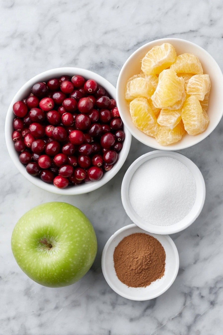 Flat lay of fresh whole cranberries, a small whole navel orange cut into chunky pieces showing its bright peel and juicy segments, a whole Granny Smith apple quartered with crisp green skin, a small white ceramic bowl filled with white granulated sugar, and a tiny white ceramic bowl containing warm brown ground cinnamon, all arranged in perfect symmetry on a clean white marble surface, soft natural light, photo taken with an iPhone, professional food photography style, fresh ingredients, white ceramic bowls, no bottles, no duplicates, no utensils, no packaging --ar 2:3 --v 7 --p m7354615311229779997 - Easy Cranberry Orange Relish, Cranberry Orange Relish, holiday side dish with cranberries and orange, quick festive relish, homemade cranberry orange salsa