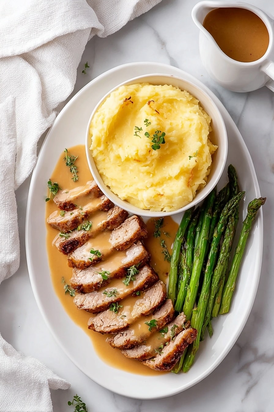 The image shows a white oval plate with three layers of food arranged neatly. On the top right, there is a white bowl filled with smooth, light yellow mashed potatoes, sitting on the plate. Below the bowl, two rows of sliced, cooked meat lay side by side, coated with a light brown sauce and garnished with small green herb leaves. On the bottom right corner of the plate, a bunch of green asparagus spears is placed parallel to the meat. The plate rests on a white marbled surface, and a white cloth is partially visible on the left side. There is also a small pitcher with brown sauce near the top right corner. Photo taken with an iphone --ar 2:3 --v 7 - Garlic Turkey Tenderloin with Easy Gravy, Turkey tenderloin recipes, quick turkey dinner, comfort food turkey, garlicky gravy recipes