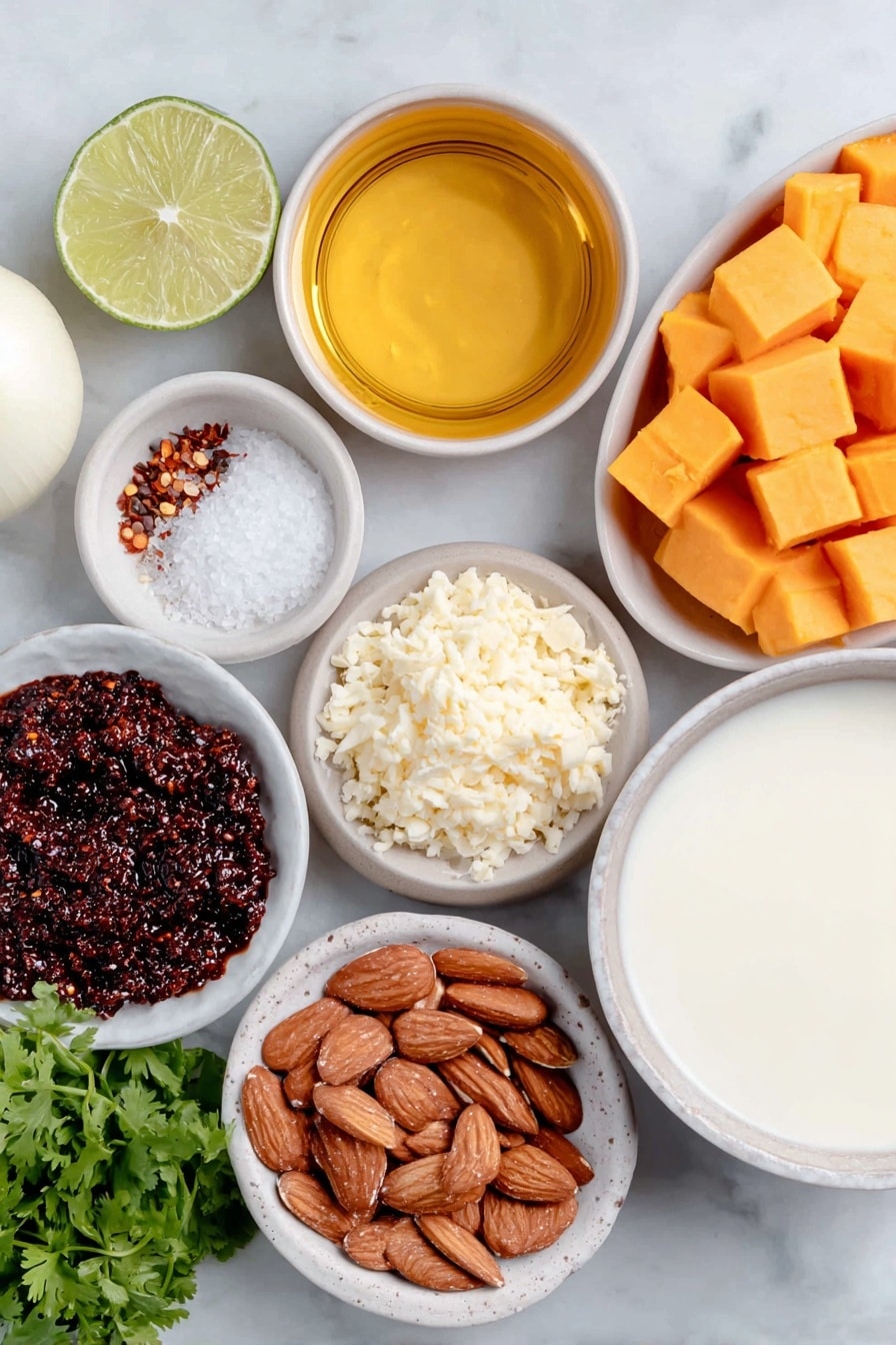 Flat lay of a small white ceramic bowl of golden oil, one whole white onion with smooth skin, a small mound of freshly minced ginger, vibrant orange cubed butternut squash, a small white ceramic bowl holding deep red curry paste, another small white bowl with creamy smooth almond butter, a simple white bowl filled with light-colored vegetable broth, a white ceramic bowl containing thick full fat coconut milk, half a fresh green lime cut open showing juicy segments, a small white bowl of coarse salt crystals, a tiny white bowl of ground black pepper, a small neat pile of roasted sliced almonds, a handful of bright green chopped cilantro, and a small white bowl holding red chili flakes, all arranged with perfect symmetry on a clean white marble surface, soft natural light, photo taken with an iPhone, professional food photography style, fresh ingredients, white ceramic bowls, no bottles, no duplicates, no utensils, no packaging --ar 2:3 --v 7 --p m7354615311229779997 - Instant Pot Thai Butternut Squash Soup, Thai butternut squash soup recipe, spicy butternut squash soup, quick healthy soup, cozy fall soup