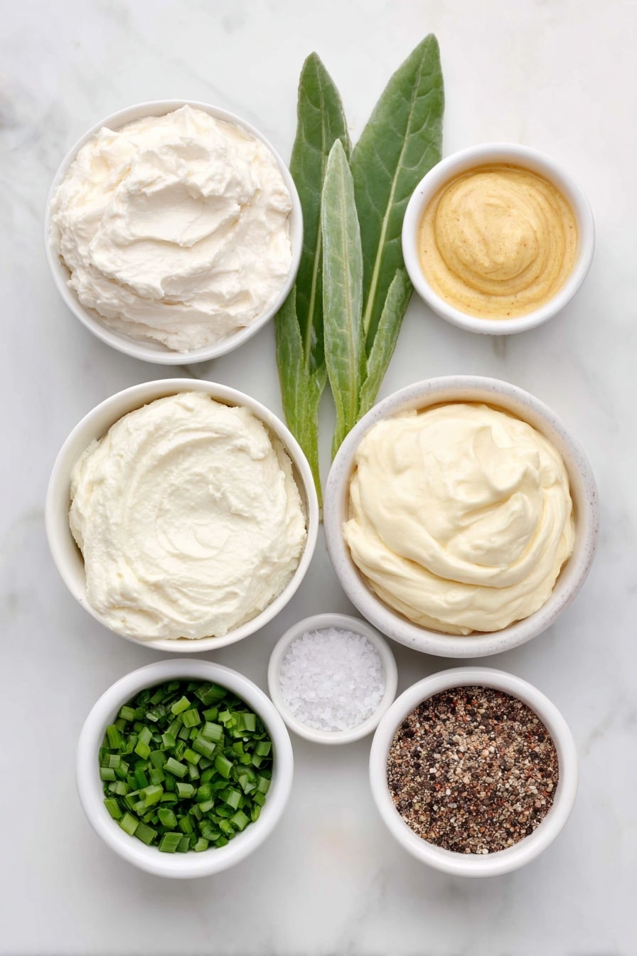Flat lay of a small white ceramic bowl of creamy sour cream, a small white ceramic bowl with a dollop of prepared horseradish root next to a few fresh horseradish leaves, a small white ceramic bowl of smooth mayonnaise, a small white ceramic bowl containing bright green finely chopped chives, a small white ceramic bowl of golden Dijon mustard, a small white ceramic bowl with coarse kosher salt crystals, and a small white ceramic bowl with freshly ground black pepper, all arranged symmetrically and balanced, placed on a clean white marble surface, soft natural light, photo taken with an iPhone, professional food photography style, fresh ingredients, white ceramic bowls, no bottles, no duplicates, no utensils, no packaging --ar 2:3 --v 7 --p m7354615311229779997 - Horseradish Sauce for Prime Rib and Steak, horseradish sauce, prime rib sauce, steak condiments, easy beef sauce