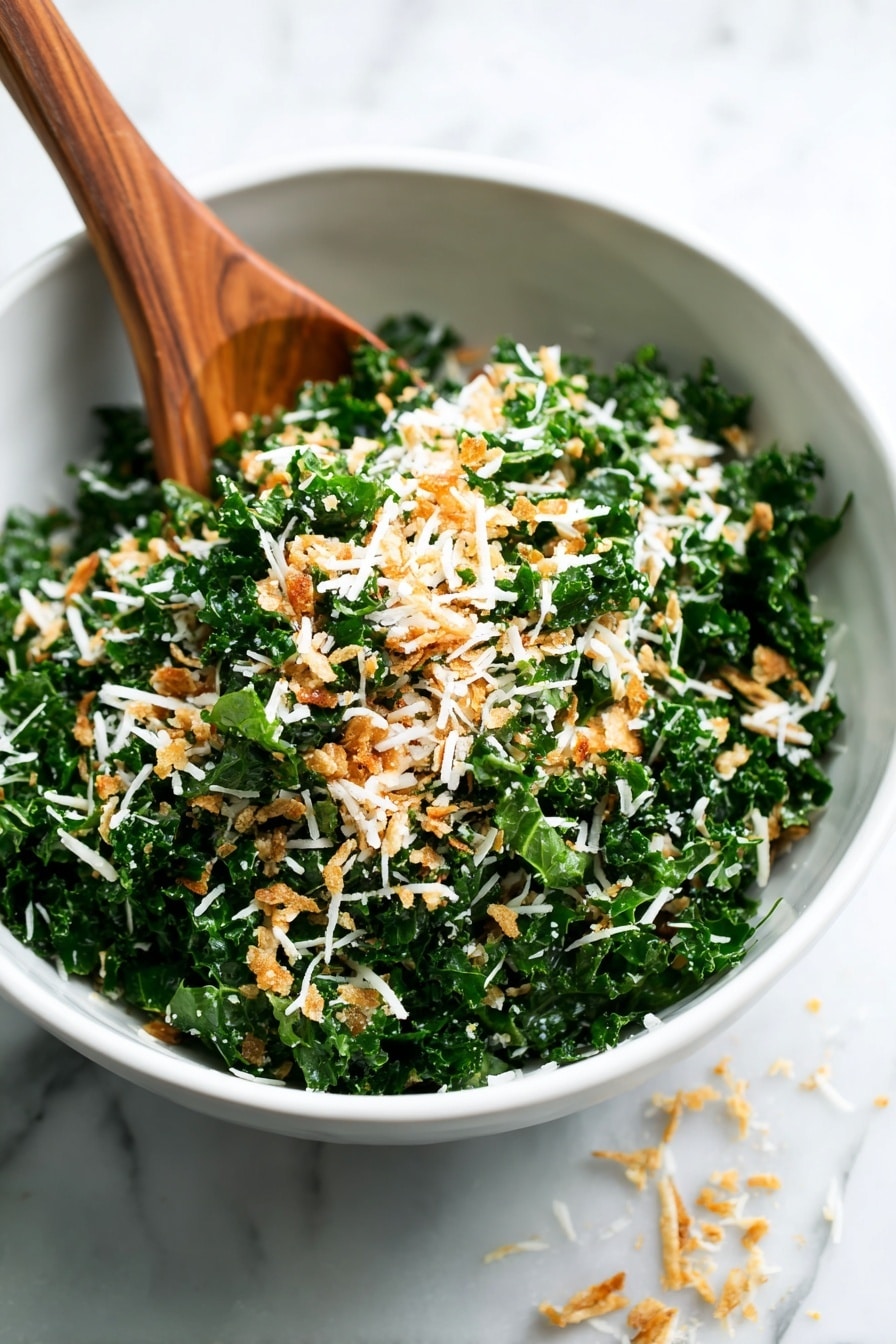 A close-up view of a white bowl filled with a green kale salad mixed with white shredded cheese and small golden brown crumb pieces, suggesting a mix of crunchy and soft textures. A wooden spoon is partially inside the bowl on the left side, stirring or resting above the salad. Some shredded cheese pieces are scattered on the white marbled surface around the bowl. The focus is sharp on the front part of the salad, while the background parts blur softly. photo taken with an iphone --ar 2:3 --v 7 - Toasted Bread Parmesan Kale Salad, healthy kale salad with crunchy breadcrumbs, easy kale salad recipes, flavorful vegetable salads, quick vegetable salads