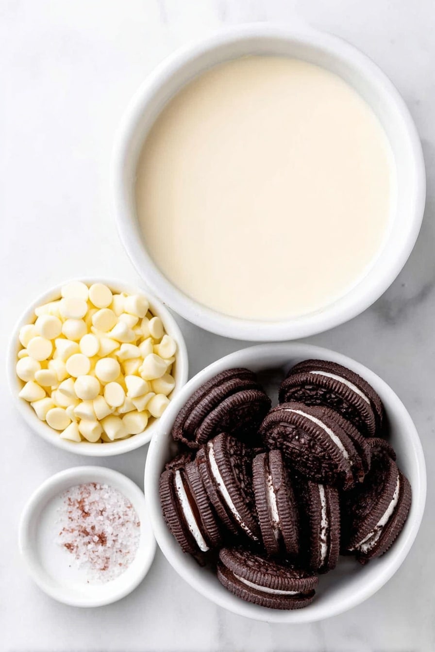 Flat lay of a small mound of glossy white chocolate chips, a simple white ceramic bowl filled with smooth, creamy condensed milk, a neat pile of crushed black-and-white Oreo cookie pieces showing the chocolate cookie and creamy filling contrast, and a tiny pinch of coarse white sea salt on a white ceramic spoon rest, all arranged in perfect symmetry placed on a clean white marble surface, soft natural light, photo taken with an iPhone, professional food photography style, fresh ingredients, white ceramic bowls, no bottles, no duplicates, no utensils, no packaging --ar 2:3 --v 7 --p m7354615311229779997 - White Chocolate Oreo Fudge, easy Oreo fudge, no-bake Oreo dessert, creamy Oreo fudge, Oreo cookie fudge recipe