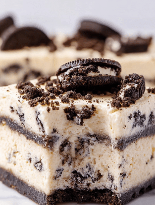 This image shows a close-up of a square dessert made of four thick layers. The base layer is creamy white with bits of dark brown cookie mixed inside. Above this is a thin, even layer of dark brown cookie pieces. The next layer is another thick creamy white layer with small cookie bits scattered throughout. The top layer is a smooth cream color studded with large crumbled pieces of dark brown cookie, some sitting on the surface. The dessert sits on a white marbled surface, and one edge shows a bite taken out. The texture looks soft and slightly firm. Photo taken with an iphone --ar 2:3 --v 7 - White Chocolate Oreo Fudge, easy Oreo fudge, no-bake Oreo dessert, creamy Oreo fudge, Oreo cookie fudge recipe