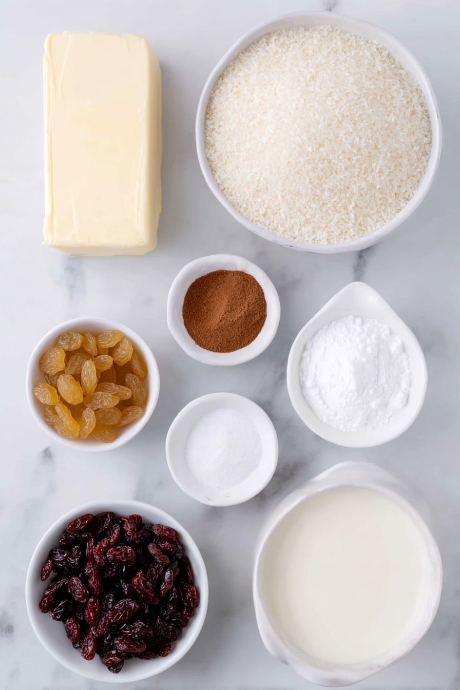 Flat lay of unsalted butter pat, a small white ceramic bowl of whole milk, a small white ceramic bowl of white sugar, a small white ceramic bowl of vanilla extract, a small white ceramic bowl of uncooked medium grain white rice, a small white ceramic bowl of golden sultanas, a small white ceramic bowl of ground cinnamon, a small white ceramic bowl of thickened cream, placed on a clean white marble surface, soft natural light, photo taken with an iPhone, professional food photography style, fresh ingredients, white ceramic bowls, no bottles, no duplicates, no utensils, no packaging --ar 2:3 --v 7 --p m7354615311229779997 - Creamy Cinnamon Rice Pudding, rice pudding with cinnamon and sultanas, easy rice pudding dessert, comforting cinnamon rice pudding, classic rice pudding recipe