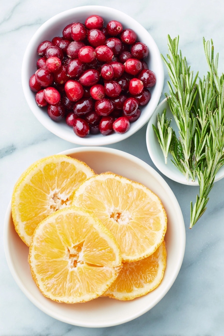 Flat lay of fresh orange slices arranged in a simple white ceramic bowl, a small white bowl filled with bright red cranberries, a small white bowl holding glossy pomegranate seeds, fresh rosemary sprigs laid neatly beside the bowls, all placed on a clean white marble surface, soft natural light, photo taken with an iPhone, professional food photography style, fresh ingredients, white ceramic bowls, no bottles, no duplicates, no utensils, no packaging --ar 2:3 --v 7 --p m7354615311229779997 - Festive Cranberry Orange Punch, holiday fruit punch, Christmas party drink, citrus holiday cocktail, easy holiday punch