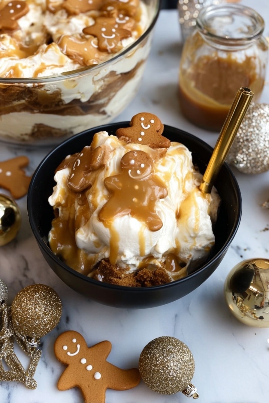 A black bowl filled with a layered dessert featuring white cream or marshmallow at the top, drizzled with light brown caramel sauce, and topped with small gingerbread man cookies that have a light brown color and smiling faces. The dessert shows a darker brown crumbly layer near the bottom contrasting with the creamy top. The bowl is placed on a white marbled surface, surrounded by more gingerbread cookies shaped like men and bells, along with two sparkly gold ornaments and a small jar of caramel sauce beside the bowl. A gold spoon rests inside the bowl, slightly submerged in the dessert. In the background, a glass bowl holds more of the same layered dessert. Photo taken with an iphone --ar 2:3 --v 7 - Gingerbread Trifle Dessert, gingerbread layered dessert, holiday trifle recipes, no-bake festive desserts, gingerbread holiday treat