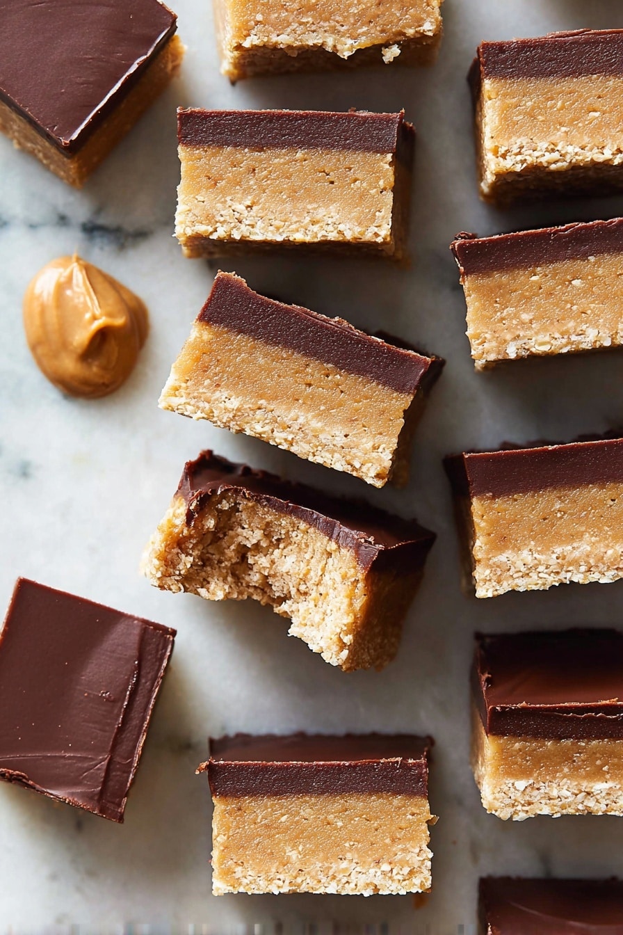 The image shows multiple small square bars stacked closely together on a white marbled surface. Each bar has two clear layers: the bottom and larger layer is thick, light tan with a grainy, crumbly texture, while the top layer is thinner, smooth, and dark brown, resembling chocolate. One bar near the center has a bite taken out of it, showing more of the inside of the tan layer. There is a small dollop of smooth tan spread in the upper left corner on the marble surface. The colors contrast well with the white marbled background, and the bars have clean sharp edges. Photo taken with an iphone --ar 2:3 --v 7 - No-Bake Chocolate Peanut Butter Bars, quick peanut butter chocolate bars, easy no-bake dessert, peanut butter chocolate treats, simple no-bake recipes