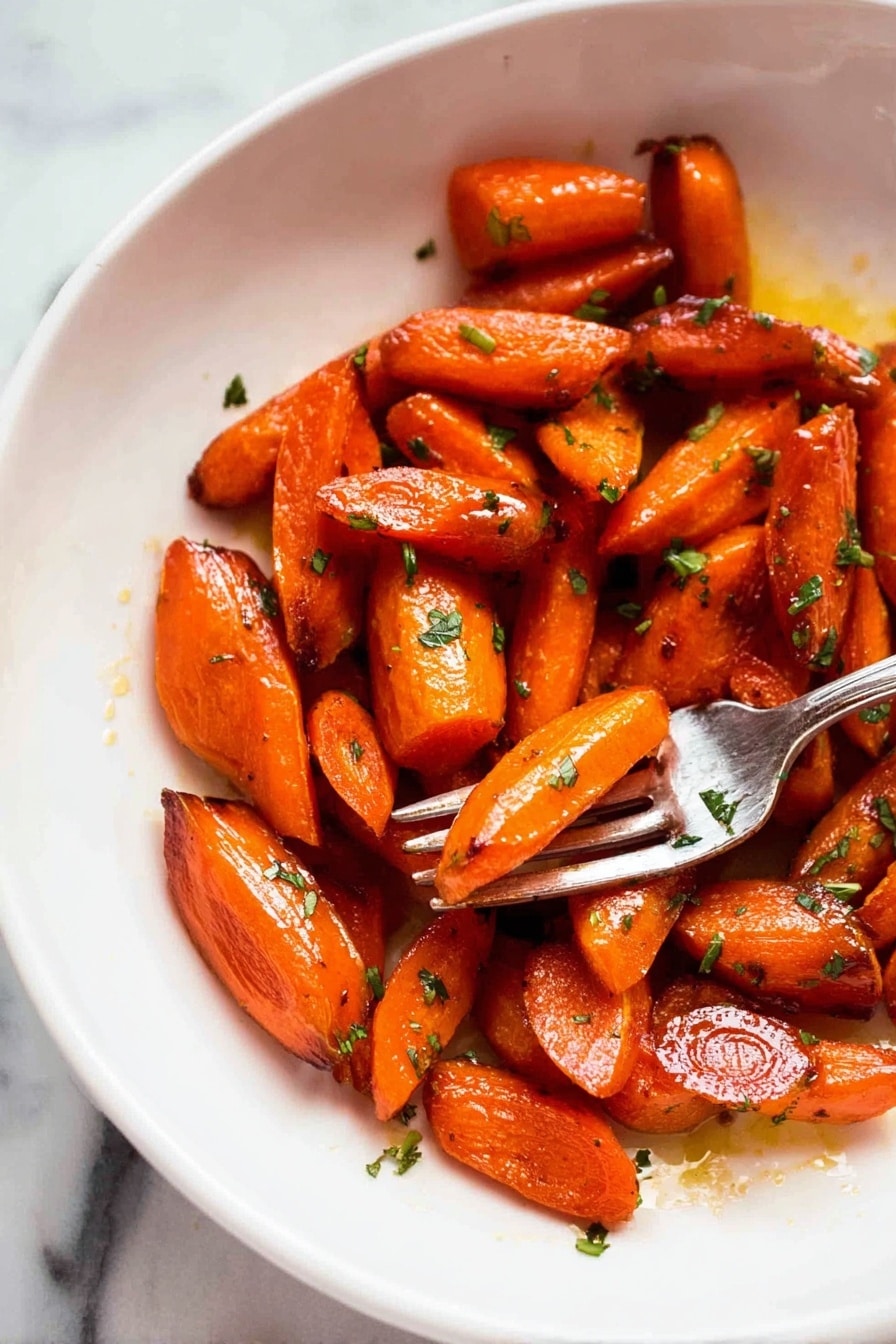 The image shows a white plate with a pile of roasted carrot pieces that are cut into small segments of different shapes, mostly oblong and triangular. The carrots are shiny with a glaze making them look moist and caramelized, with some darker browned spots on the edges indicating roasting. Small bits of green herbs are scattered over the carrots, adding a fresh contrast to the bright orange color. On the right side of the plate, a silver fork holds a piece of carrot above the surface. The background is a white marbled texture. photo taken with an iphone --ar 2:3 --v 7 - Brown Sugar Roasted Carrots, roasted carrot side dish, caramelized carrots recipe, sweet savory roasted carrots, easy veggie side dishes