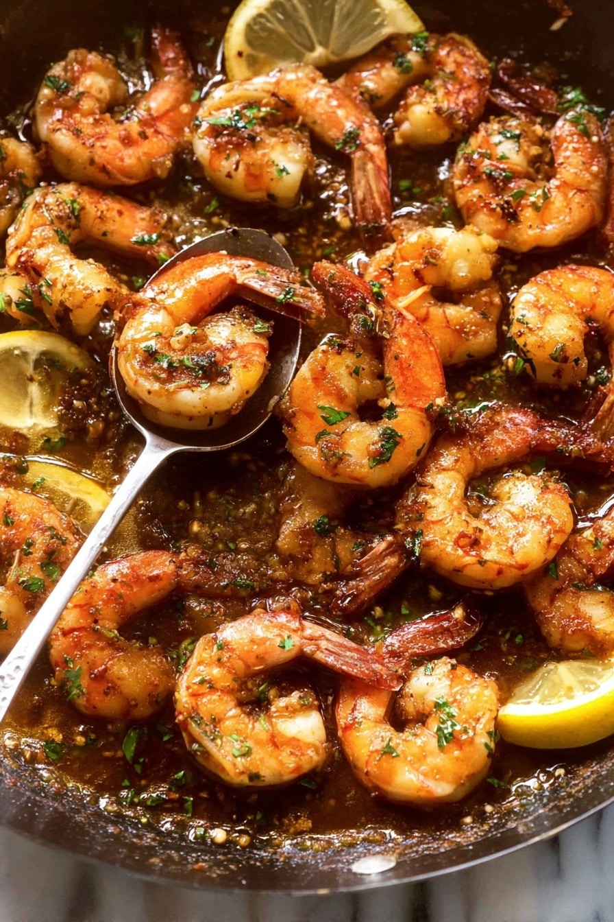 The image shows a close-up view of cooked shrimp piled on a white plate. The shrimp are orange with charred marks and sprinkled with small green herb flakes. A spoon is held above the shrimp by a woman's hand, dripping a golden sauce onto them. The background surface is a white marbled texture. photo taken with an iphone --ar 2:3 --v 7 - Garlic Prawns, garlic prawns recipe, easy seafood dinner, quick prawn dish, lemon garlic prawns