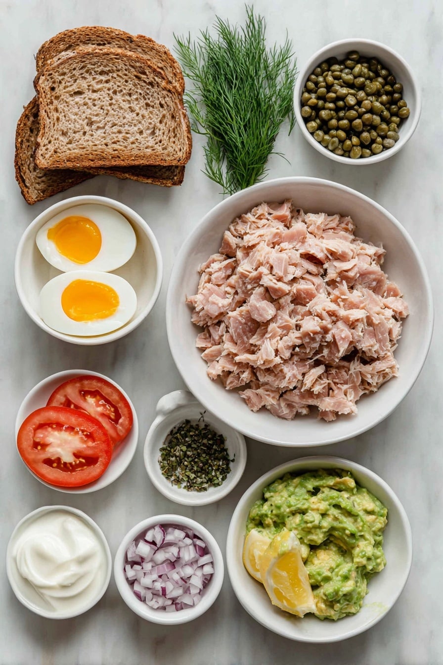 Flat lay of a simple white ceramic bowl of flaked tuna, a few finely diced red onion pieces in a small white bowl, a small white bowl with drained green capers, a small bunch of fresh dill sprigs, a small white bowl of smooth Dijon mustard, a small white bowl filled with creamy plain Greek yogurt, a small white bowl with fresh lemon juice, two whole uncracked brown eggs, two slices of toasted whole wheat bread on a white plate, a small white bowl with mashed ripe avocado, a small white bowl holding vibrant green pesto, two thick slices of ripe red tomato, sprinkled salt and pepper grains artistically arranged, all ingredients fresh and natural, perfectly balanced and symmetrical layout placed on a clean white marble surface, soft natural light, photo taken with an iPhone, professional food photography style, fresh ingredients, white ceramic bowls, no bottles, no duplicates, no utensils, no packaging --ar 2:3 --v 7 --p m7354615311229779997 - Tunacado Sandwich with Tuna and Avocado, healthy tuna sandwich, avocado tuna salad, quick lunch ideas, nutritious sandwich recipes