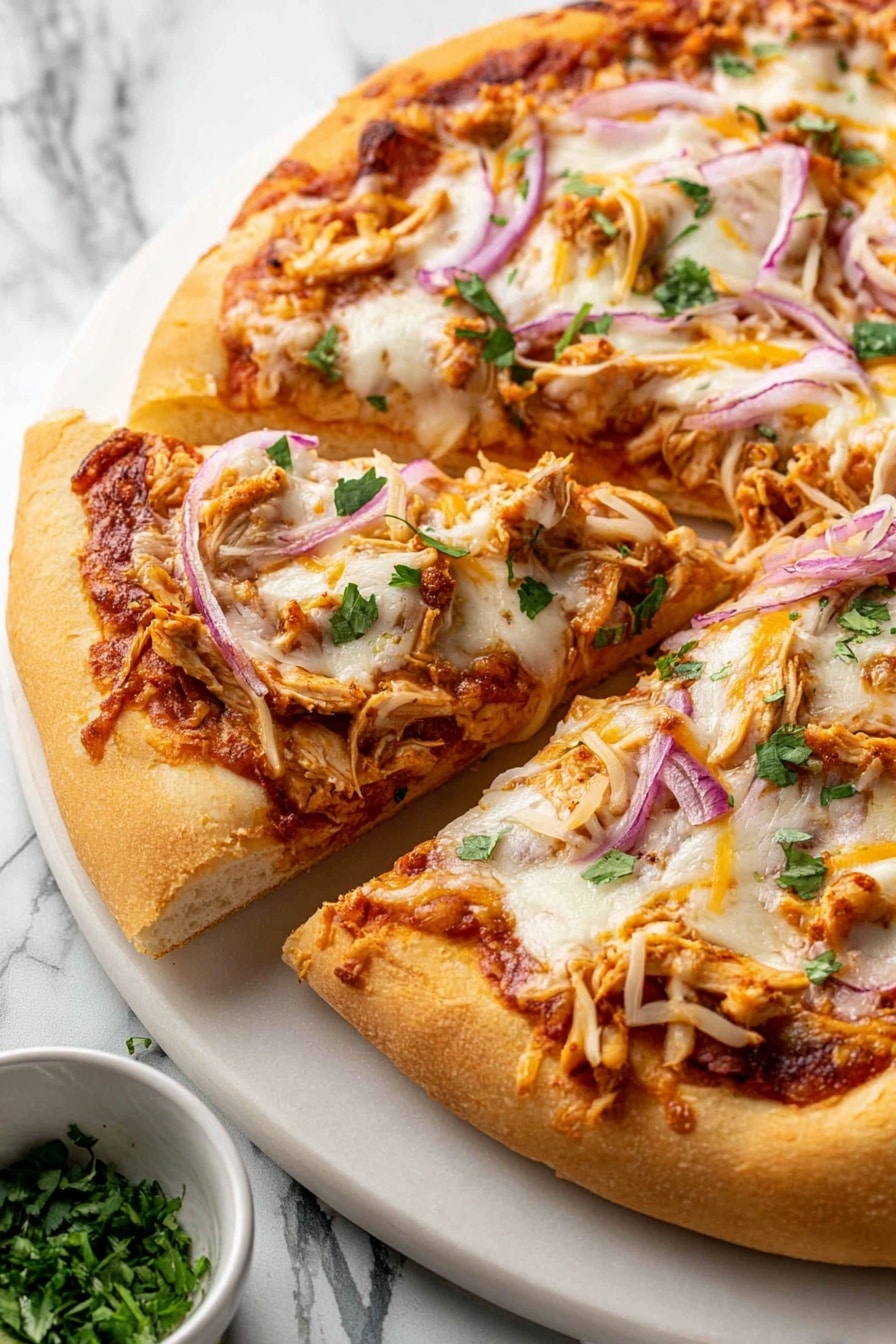 A close-up view of a pizza with a thick, golden brown crust. It has one base layer of reddish tomato sauce spread evenly, topped with a melted white cheese layer that looks soft and stretchy. On top, there are thin slices of purple onion, small pieces of light brown chicken, shredded yellow cheese, and scattered green herb bits. One slice is slightly pulled away from the rest, showing the fluffy inside of the crust. The pizza sits on a white plate placed on a white marbled surface, with a small bowl of green herbs nearby. photo taken with an iphone --ar 2:3 --v 7 - BBQ Chicken Pizza with Smoked Gouda, BBQ Chicken Pizza, smoky Gouda pizza, homemade BBQ chicken pizza, easy BBQ pizza recipe