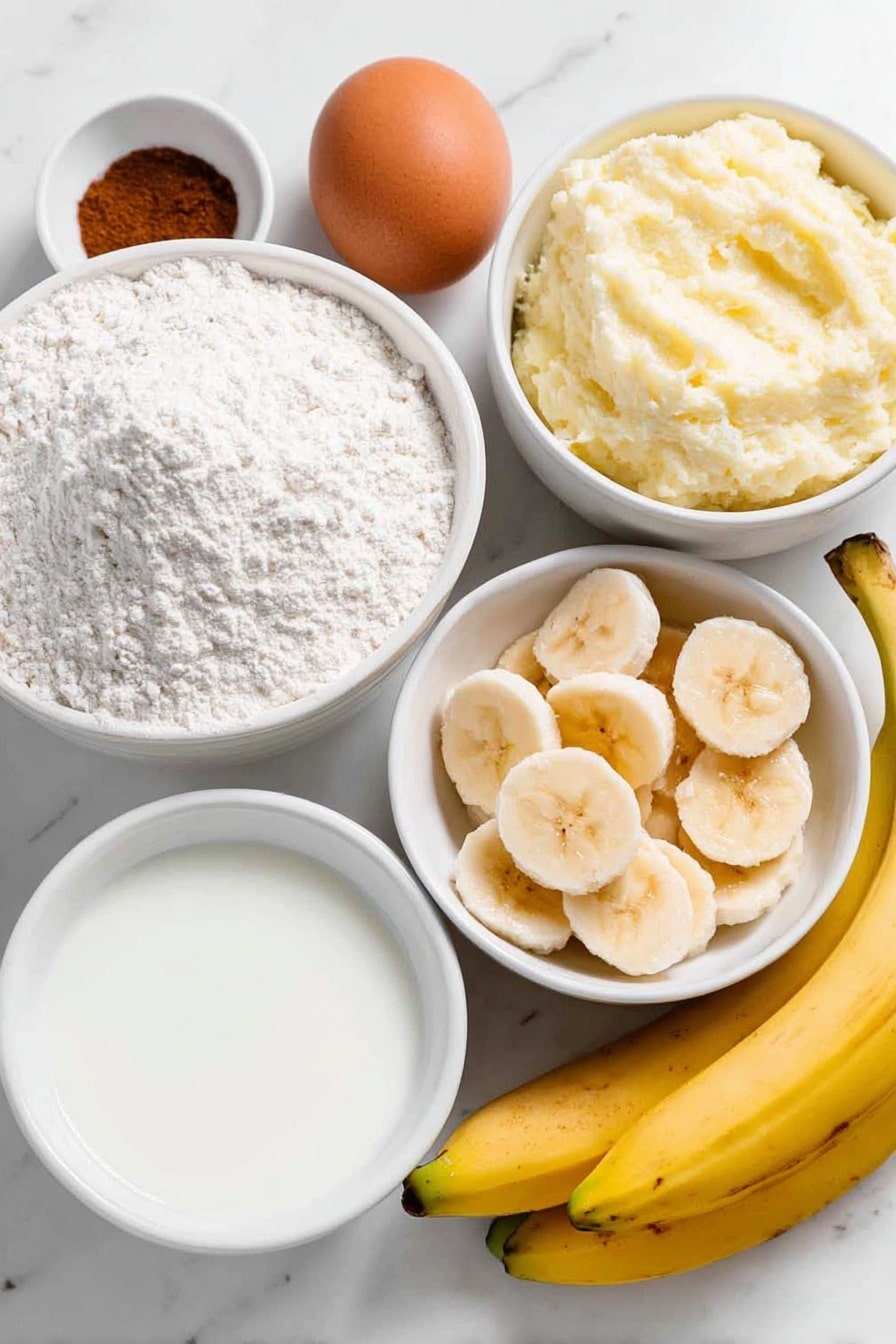 Flat lay of a small mound of all-purpose flour, a white ceramic bowl with aluminum-free baking powder, a small white bowl containing ground cinnamon, a small white bowl of fine salt, a medium white bowl filled with mashed overripe banana, one large whole brown egg with a clean shell, a white ceramic bowl with fresh milk, a white ceramic bowl of golden maple syrup, and a few fresh banana slices artfully arranged beside the bowls, all ingredients fresh and natural, perfect symmetry, placed on a clean white marble surface, soft natural light, photo taken with an iPhone, professional food photography style, fresh ingredients, white ceramic bowls, no bottles, no duplicates, no utensils, no packaging --ar 2:3 --v 7 --p m7354615311229779997 - Banana Pancakes, easy banana pancakes, fluffy banana pancakes, breakfast banana pancakes, healthy banana pancakes