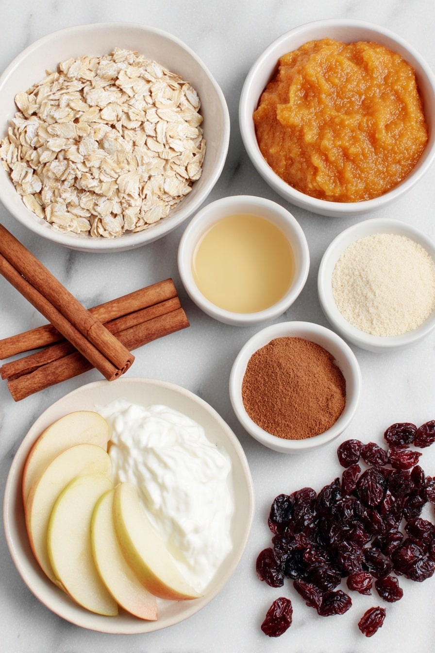 Flat lay of old fashioned rolled oats loosely piled beside a small white ceramic bowl of smooth bright orange pumpkin puree, a few whole cinnamon sticks arranged near a white bowl holding ground cinnamon, a tiny white bowl with finely ground ginger, a white bowl with ground allspice, another small white bowl of ground nutmeg, a small white bowl filled with pure golden maple syrup, a small white bowl containing creamy almond milk, a neat cluster of crisp apple slices next to plump fresh blueberries, a dollop of thick creamy white Greek yogurt on a white ceramic plate, a small pile of toasted pecans placed nearby, a few golden raisins and deep red dried cranberries scattered gently on the surface, all ingredients fresh and natural, balanced symmetrically across a clean white marble surface, soft natural light, photo taken with an iPhone, professional food photography style, fresh ingredients, white ceramic bowls, no bottles, no duplicates, no utensils, no packaging --ar 2:3 --v 7 --p m7354615311229779997 - Creamy Pumpkin Oatmeal with Warm Spices, pumpkin oatmeal recipe, cozy fall breakfast, healthy pumpkin oatmeal, easy breakfast with pumpkin