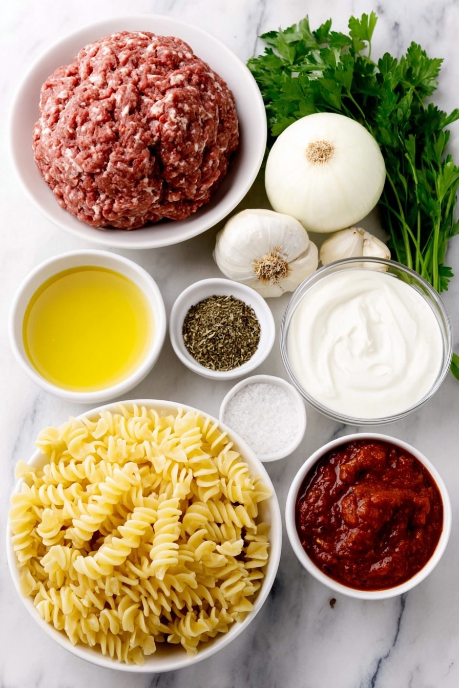 Flat lay of a small pool of golden olive oil in a simple white ceramic bowl, two whole uncracked brown garlic cloves, a peeled white onion cut in half showing its layers, a mound of fresh raw ground beef, a small white bowl filled with mixed Italian dried herbs, a small white bowl with deep red tomato paste, a small white bowl with crushed ripe red tomatoes, a few bright red chili flakes scattered beside a small white bowl of kosher salt crystals, a small white bowl of whole black peppercorns, a small white bowl filled with clear chicken stock, a neat pile of uncooked fusilli pasta, a small white bowl holding thick heavy cream, a small white ceramic bowl filled with finely grated pale yellow Parmesan cheese, a few sprigs of fresh bright green parsley placed gracefully, all placed on a clean white marble surface, soft natural light, photo taken with an iPhone, professional food photography style, fresh ingredients, white ceramic bowls, no bottles, no duplicates, no utensils, no packaging --ar 2:3 --v 7 --p m7354615311229779997 - Creamy Tomato Beef Pasta, creamy beef pasta recipe, easy beef pasta dinner, quick one-pot pasta, hearty tomato beef pasta