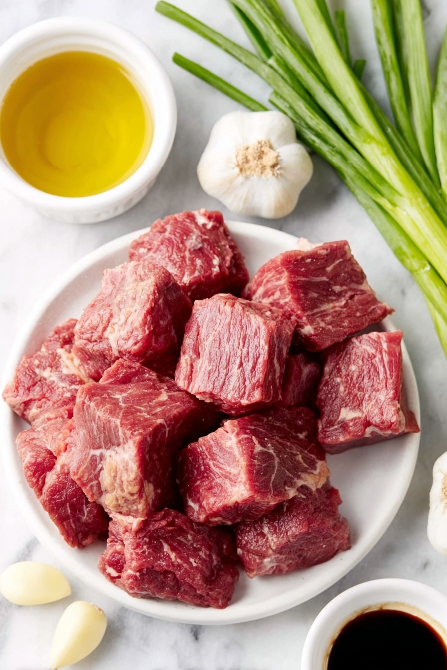 Flat lay of fresh, cubed sirloin steak pieces just under 1-inch, a few whole garlic cloves with smooth white skins, a small white ceramic bowl filled with golden honey, a small white ceramic bowl containing dark low-sodium soy sauce, a small white ceramic bowl of clear golden olive oil, and a few fresh green onions with bright green tops and white bulbs arranged neatly, all placed on a clean white marble surface, soft natural light, photo taken with an iPhone, professional food photography style, fresh ingredients, white ceramic bowls, no bottles, no duplicates, no utensils, no packaging --ar 2:3 --v 7 --p m7354615311229779997 - Garlic Honey Steak Bites, Garlic Honey Steak Bites Recipe, Easy Steak Bites, Quick Steak Dinner Ideas, Flavorful Steak Snacks