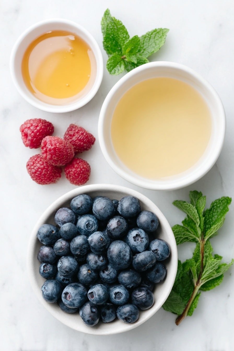 Flat lay of fresh plump blueberries in a simple white ceramic bowl, a small white bowl of golden honey, fresh ripe raspberries scattered neatly, a small white bowl filled with pale amber kombucha, a small white bowl with light golden ginger beer, and a few sprigs of fresh bright green mint arranged artistically, all placed on a clean white marble surface, soft natural light, photo taken with an iPhone, professional food photography style, fresh ingredients, white ceramic bowls, no bottles, no duplicates, no utensils, no packaging --ar 2:3 --v 7 --p m7354615311229779997 - Honey Berry Kombucha Smash, refreshing kombucha drinks, fruity summer beverages, non-alcoholic cocktail ideas, sparkling berry drinks